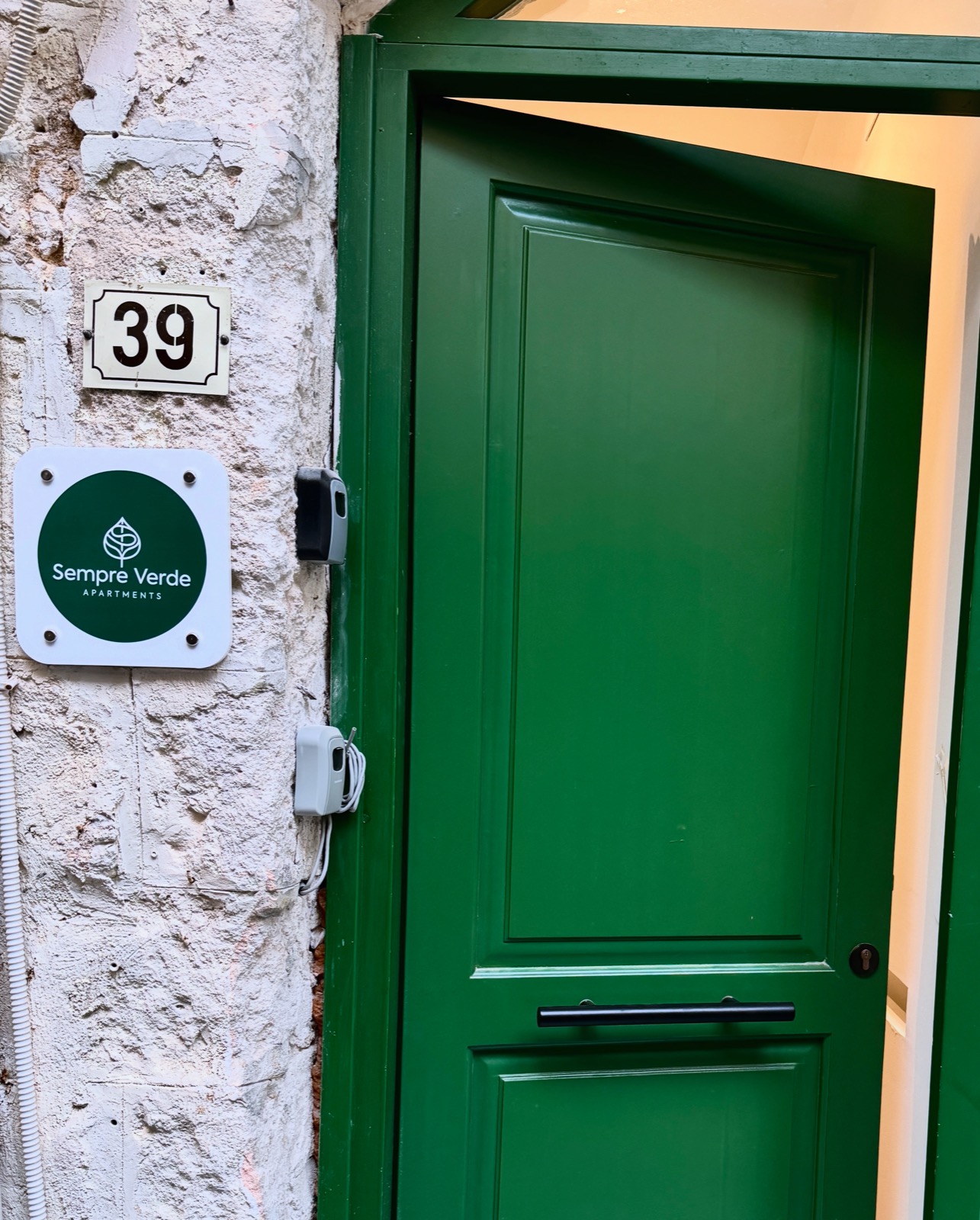 Green entrance door at Sempre Verde